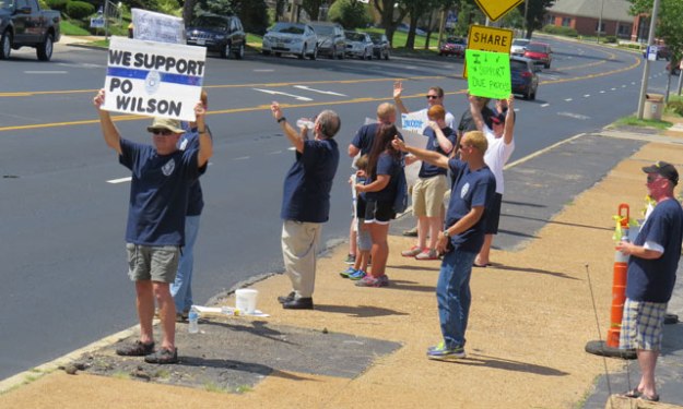 Supporters of Police Officer Darren Wilson gather outside a local bar to greet traffic and raise money for Wilson. 